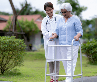 Doctor helping woman use walker