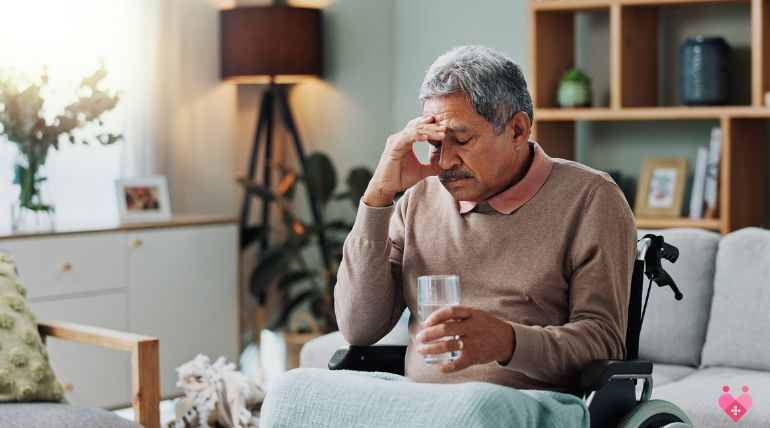 Elderly man in wheelchair looking tired