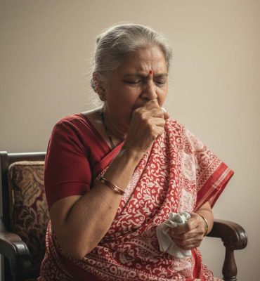 Elderly woman coughing with COPD symptoms